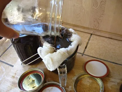 Strining iced coffee through cheesecloth